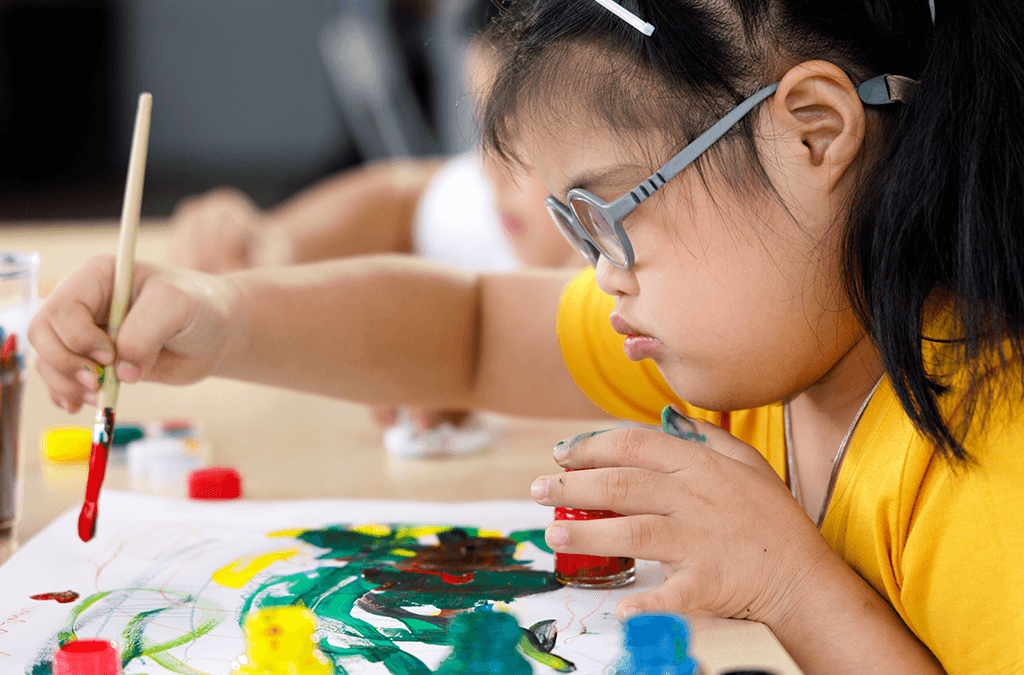 Photo of Asian girl with disability painting