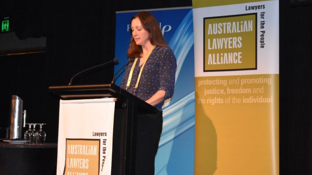 Emma Phillips at lectern giving presentation