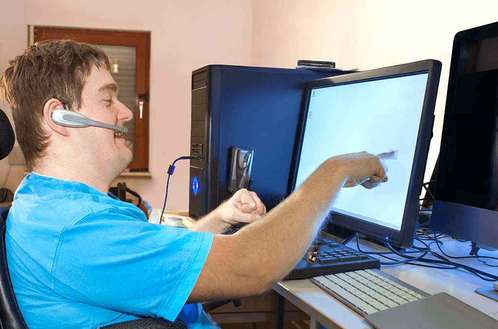 Photo of a man with disability working at computer
