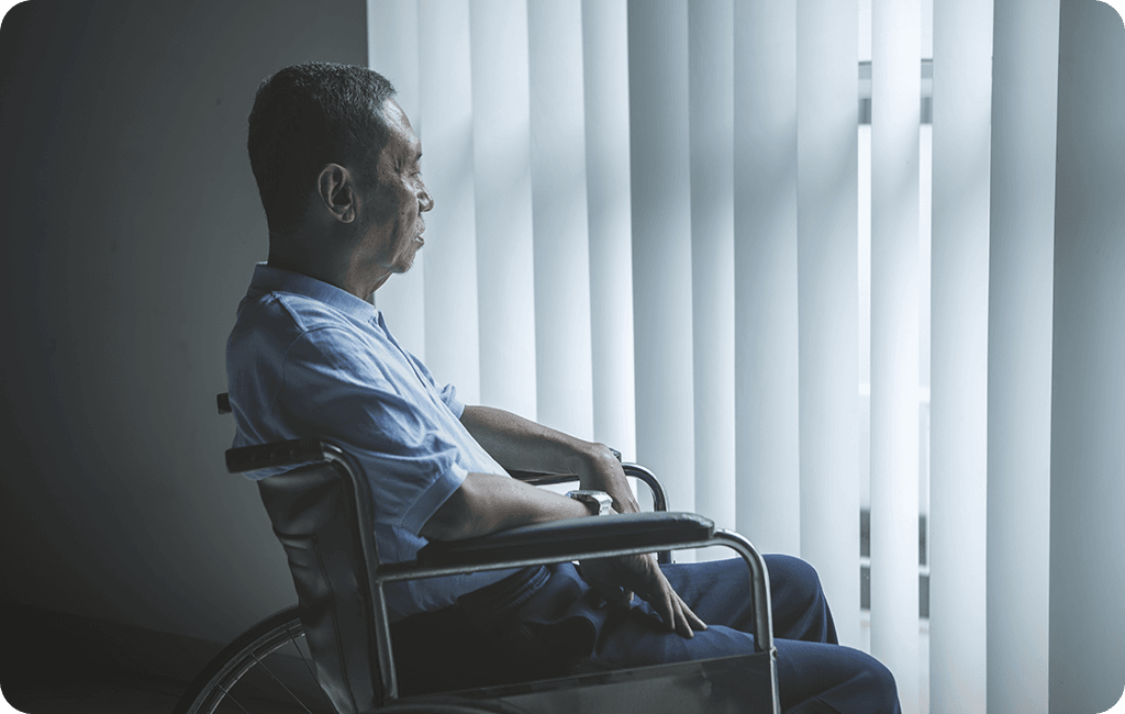 Man in wheelchair looking our window